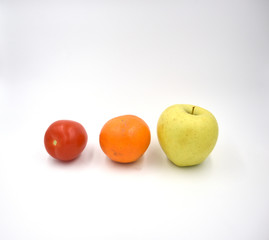 Tomato, orange, apple on the white background