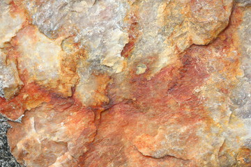 Textured of surface stone wall for background. Tone orange, brown and red color same rust.