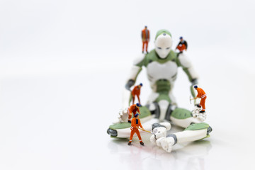Fototapeta premium Miniature people : Engineering is developing an AI robot system, using labor instead of people. Image use for new technology in the feature, business concept.