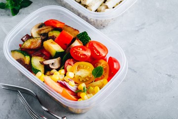Vegan meal prep lunch box container with grilled and fresh vegetables