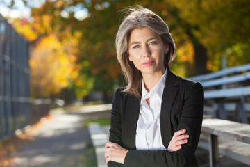 Pretty worried woman at the park.  Serious Middle Aged woman