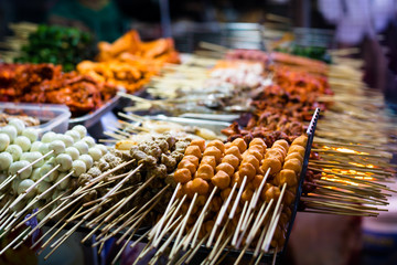 Outdoor streetfood market. Grilled BBQ meat skewers in Asia.