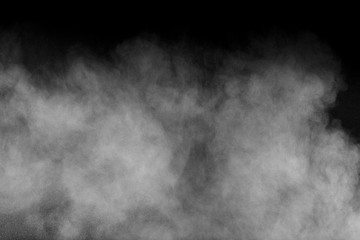 White powder explosion isolated on black background. White dust particles splash.