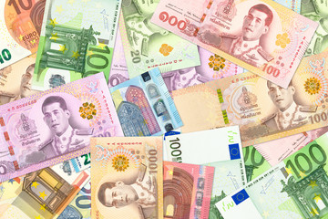 some thai baht and euro banknotes indicating trade relations