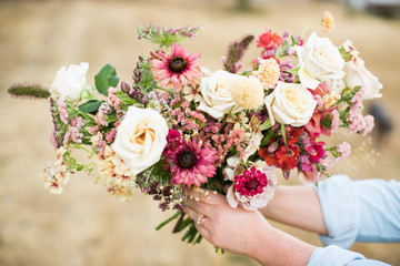 hands holding bouquet beautiful white red pink flowers roses