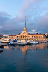 Fototapeta na wymiar Sochi Marine Station and the yacht pier at sunset.