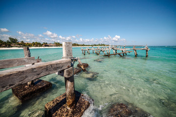 Pelicans sit on an old abandoned pier. Xpu Ha Beach, Mexico