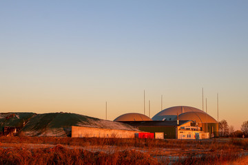 Fototapeta na wymiar Biogas plant at sunrise or sunset