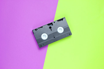 Outdated videotape on a two-ton paper background, Top view. Minimalism