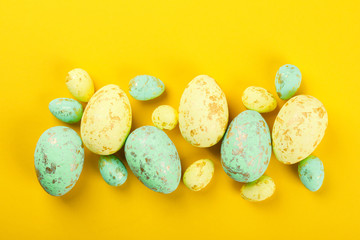 Easter background. Easter eggs  Colored, decorated with gold on yellow paper. Happy Festive concept.Top View. Flat Lay.Copy space for Text