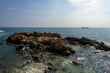 Rock in ocean. Sunset ship. Sunset sky. Sri Lanka