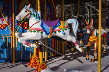 Fototapeta na wymiar Carousel in the children's Park with horses