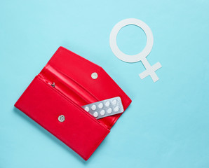 Women Health. Female gender symbol, pills in red purse on blue background.