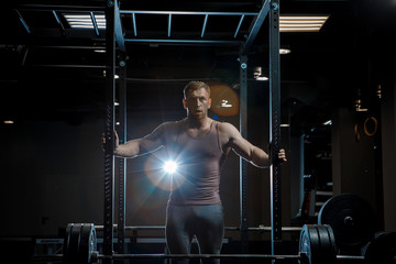 Strong man posing in gym