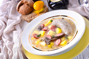 a polish easter soup with homemade white sausage and mushrooms
