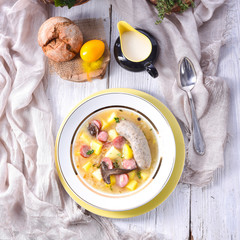 a polish easter soup with homemade white sausage and mushrooms