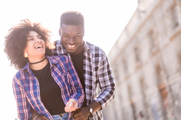 Happy black african mixed race couple laughing and enjoying the relationship and the friendship...