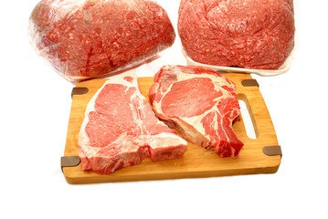 Raw Thick Pork Chops with Ground Beef in the Background