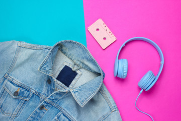 Pop culture attributes eighties. Denim jacket, headphones, audio cassette on a blue-pink...