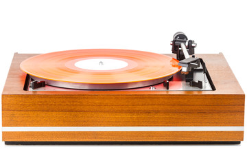 Vintage turntable with a red vinyl isolated on white