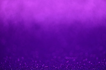 Purple glitter lights background. Defocused