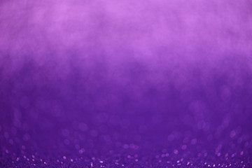 Purple glitter lights background. Defocused