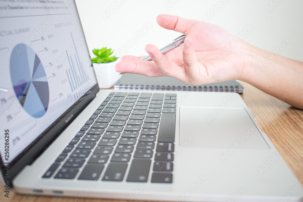 Poster closeup image of a businessman explaining financial graph on a computer screen on the desk. business