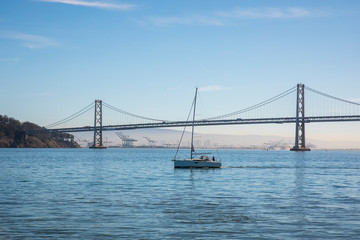 sailboat sailing the bay of San Francisco with the bridge in the background