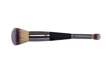 Fototapeta premium Cosmetic products isolated. Closeup of a new black and silver professional makeup brush isolated on white background. Macro. Concept beauty.