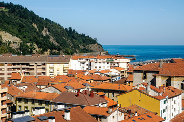 Naklejka na ściany i meble Rural town near the sea in the spanish basque country on a suuny day