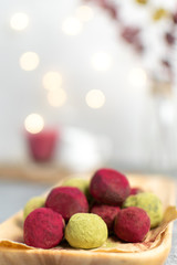 Selective focus on matcha green tea and pink raspberry beetroot truffles