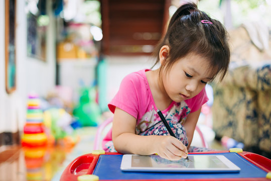 Kids using tablet for drawing : Some research says entertainment media (including TV) be avoided for infants and children under age 2 and cell phone radiation can harm your baby and may cause of ADHD.