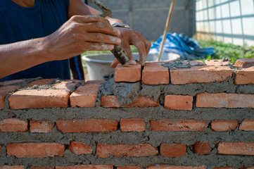 Closeup texture and background of orange bricklayers installed by worker at the construction site