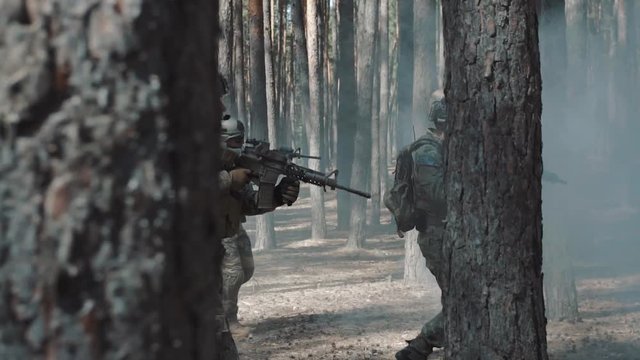 American soldiers patrol the perimeter in the forest