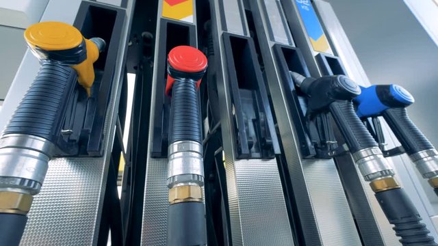 Green fuel pistol is being taken out from the gasoline pump