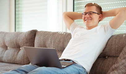 Young man working with laptop at home