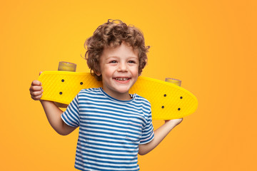 Charming boy with bright longboard 