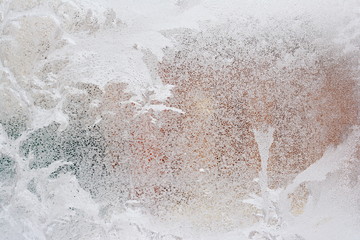 frosty pattern on glass winter window, look through glass 