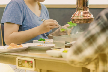 Happiness Enjoy eating Korean BBQ traditional famous food with family in a Korean restaurant , Selective focus on air pipe.