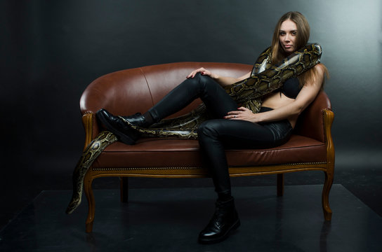 sexy woman and python in studio