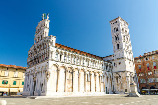 Chiesa di San Michele in Foro St Michael Roman Catholic church basilica on Piazza San Michele square in historical centre of old medieval town Lucca in summer day with clear blue sky, Tuscany, Italy