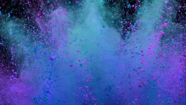 Explosion of colored powder on black background