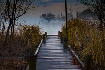 Wooden pier at lake on foggy morning
