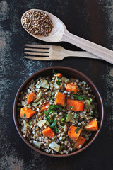 Buckwheat porridge with vegetables and herbs in a bowl. Flat lay. Healthy vegan food concept. Buckwheat diet