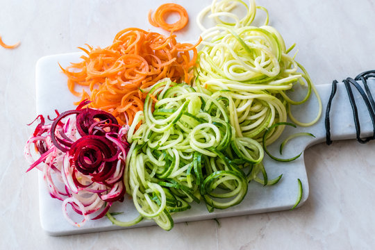 Spiralized Vegetables Noodle Carrot, Beetroot, Zucchini and Cucumber on Marble Board.