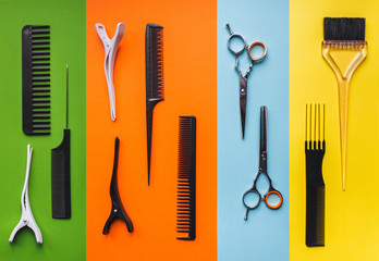 Tools hairdresser on the background of pastel paper in the form of multi-colored stripes. Minimalist pop art concept. Barbershop.