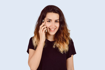 Young woman talking on phone in a studio