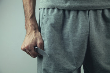 gangster threatens with a knife