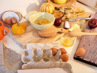 Eggs, pumpkins, onions, vegetables, sea salt on a light table, top view, home cooking ingredients, shades of yellow