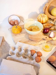 Eggs, pumpkins, onions, vegetables, sea salt on a light table, top view, home cooking ingredients, shades of yellow